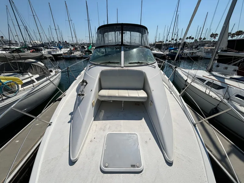 Slide: The Image of 2002 Carver 350 Mariner yacht docked in a marina, surrounded by sailboats. - 4