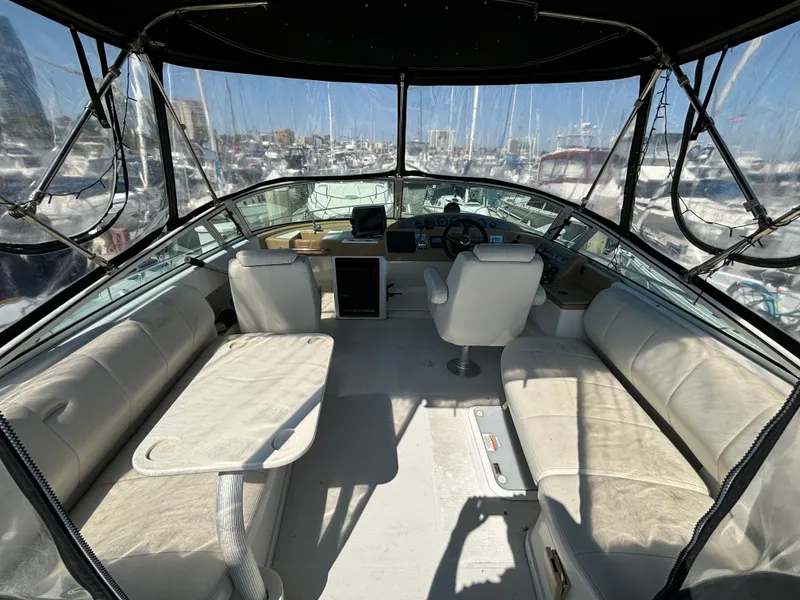 Slide: The Image of Interior of a 2002 Carver 350 Mariner yacht with seating and helm. - 6