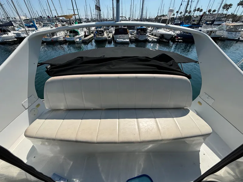 Slide: The Image of 2002 Carver 350 Mariner boat interior with white seating, docked at marina. - 8