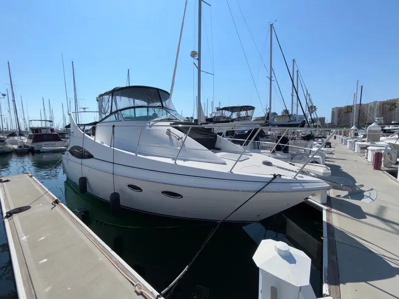 The Image of 2002 Carver 350 Mariner yacht docked at marina under clear blue sky. - 0