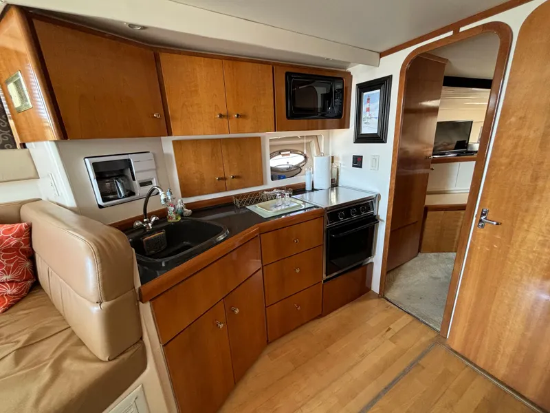 Slide: The Image of Interior of 2002 Carver 350 Mariner yacht with kitchen and wood cabinetry. - 14