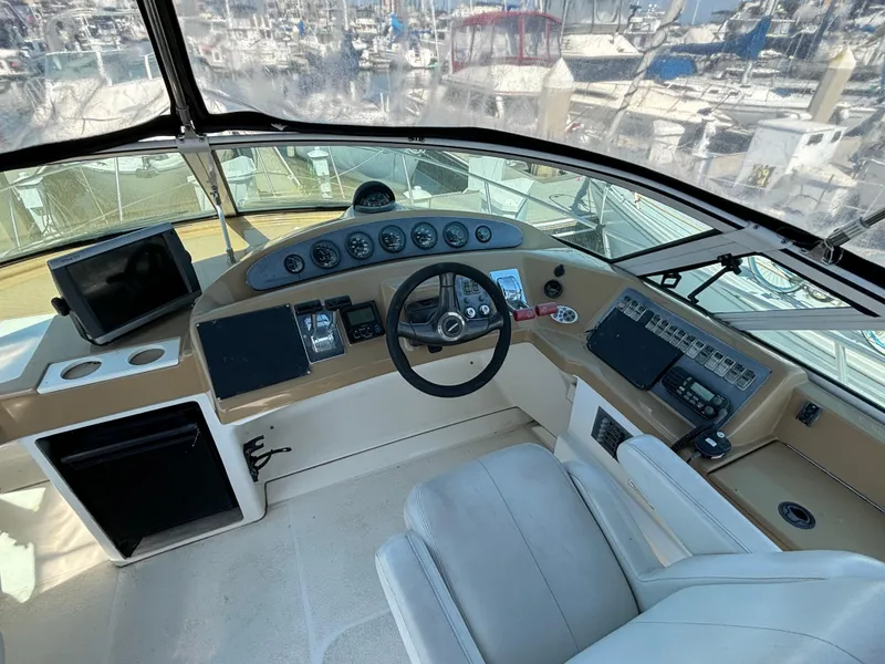 Slide: The Image of 2002 Carver 350 Mariner helm with steering wheel, gauges, and navigation equipment. - 7