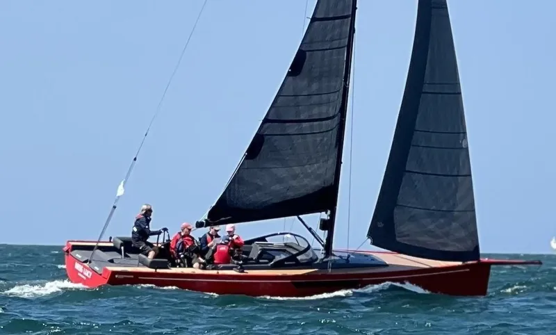 The Image of 2023 Saffier 33 Life sailboat with black sails on open water. - 0
