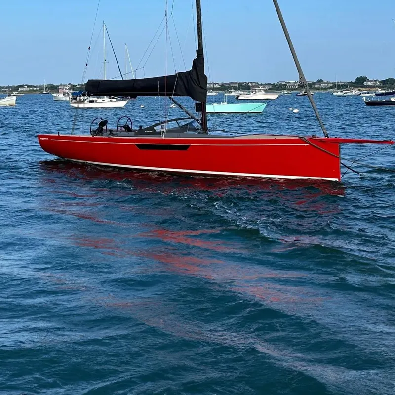 Slide: The Image of Red 2023 Saffier 33 Life sailboat on calm blue water under clear sky. - 1