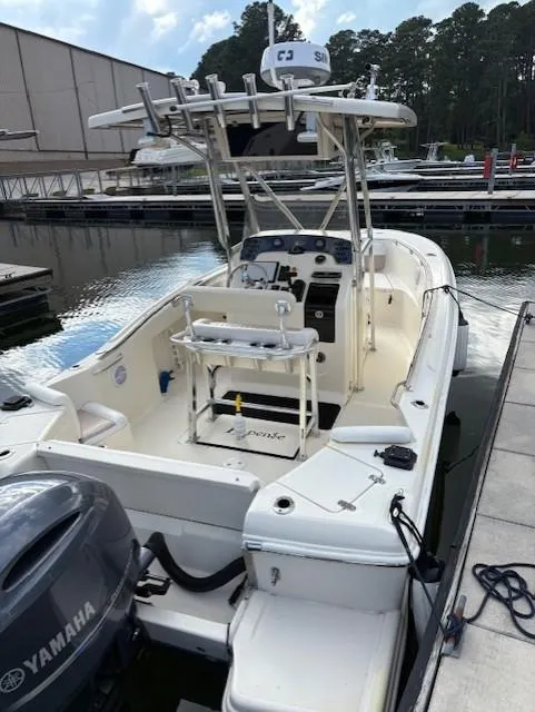 Slide: The Image of 2006 Scout 222 Sportfish boat docked, featuring Yamaha outboard motor and T-top. - 3