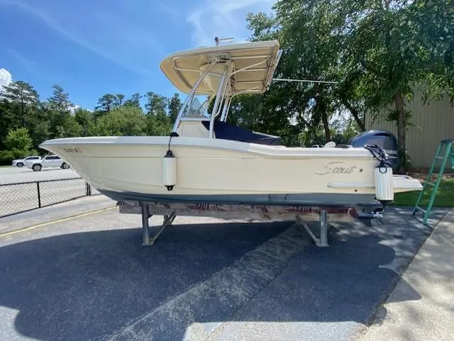Slide: The Image of 2006 Scout 222 Sportfish boat on display, featuring a sleek design and canopy. - 4