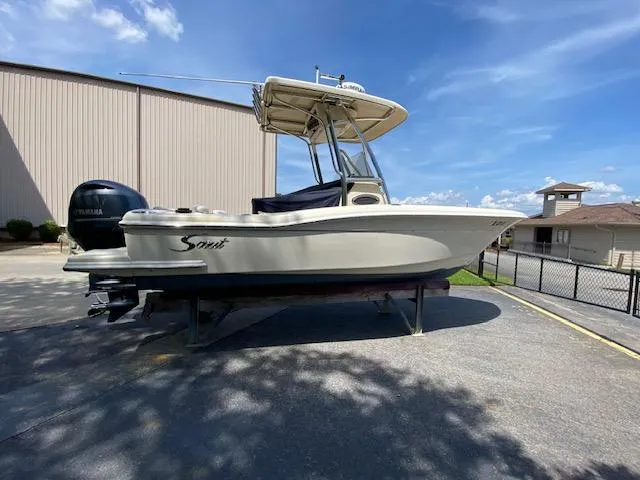 Slide: The Image of 2006 Scout 222 Sportfish boat on display under clear blue sky. - 5