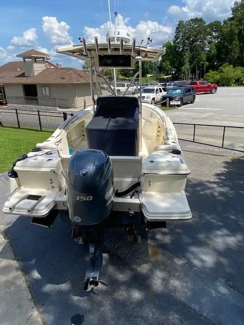 Slide: The Image of 2006 Scout 222 Sportfish boat with Yamaha 150 outboard motor in a parking area. - 6