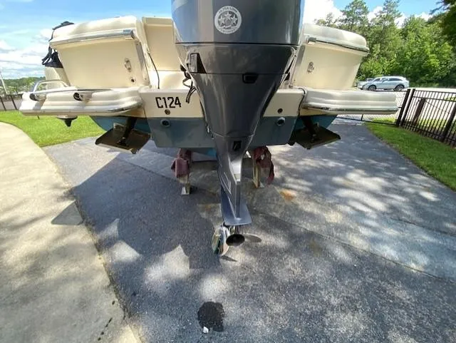 Slide: The Image of 2006 Scout 222 Sportfish boat rear view with outboard motor on driveway. - 8
