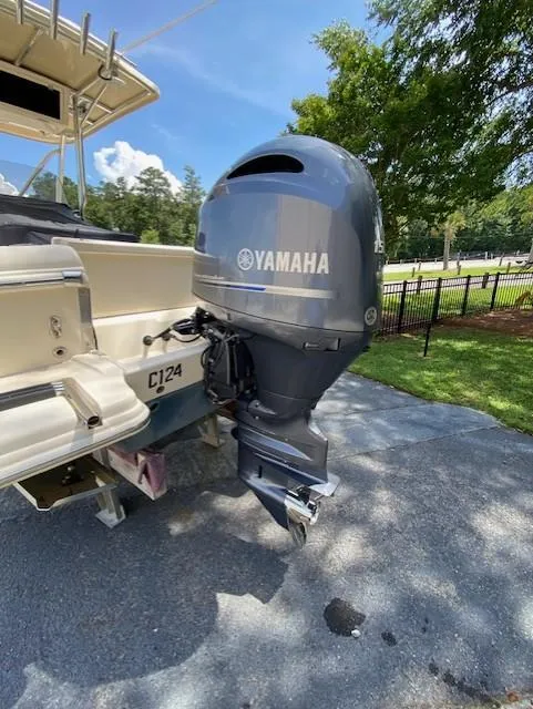 Slide: The Image of 2006 Scout 222 Sportfish boat with Yamaha outboard motor, parked outdoors. - 9