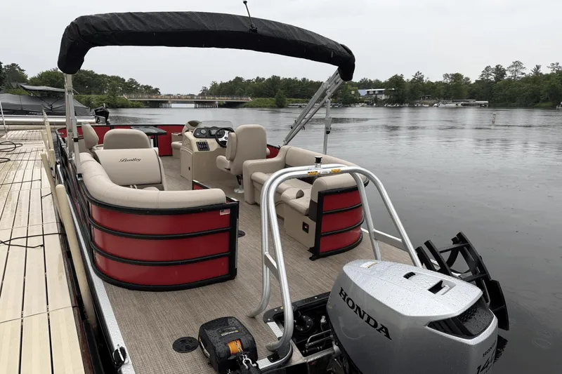 Slide: The Image of 2025 Bentley Pontoons 200 CWT FISH on a serene lake with Honda motor. - 13