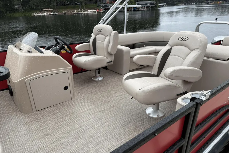 Slide: The Image of 2025 Bentley Pontoons 200 CWT FISH interior with plush seating and steering console. - 3