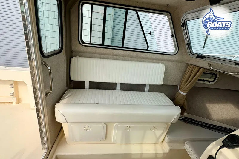 Slide: The Image of 2011 Parker Sport Cabin SL interior with white seating and windows. - 12