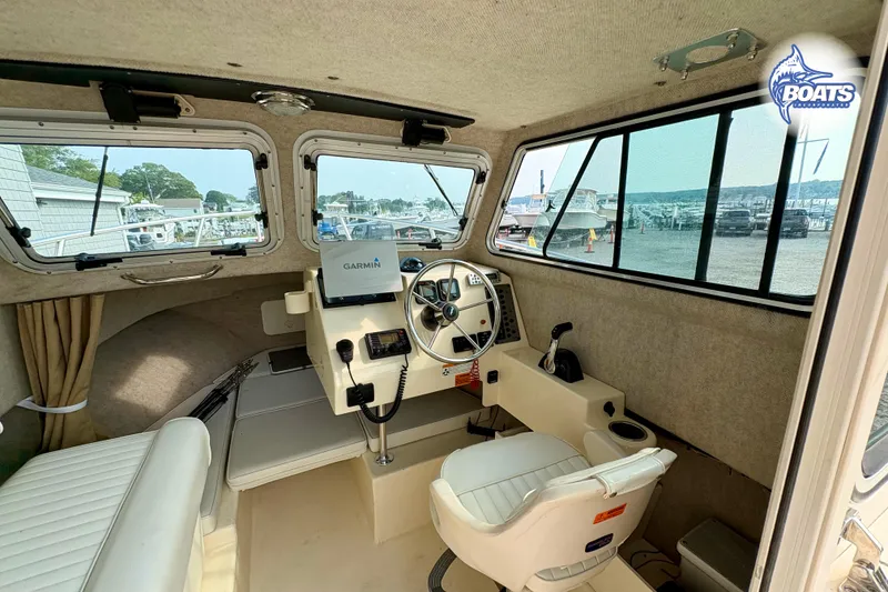 Slide: The Image of Interior of a 2011 Parker Sport Cabin SL boat with Garmin navigation system. - 13
