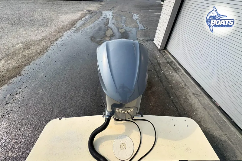 Slide: The Image of 2011 Parker Sport Cabin SL boat with Yamaha 150 outboard motor, parked near a garage. - 17