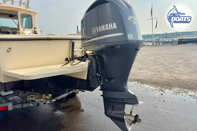 Slide: The Image of Parker Sport Cabin SL 2011 with Yamaha 250 V6 outboard motor at a marina. - 19