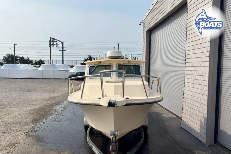 Slide: The Image of 2011 Parker Sport Cabin SL boat parked outside a building. - 3