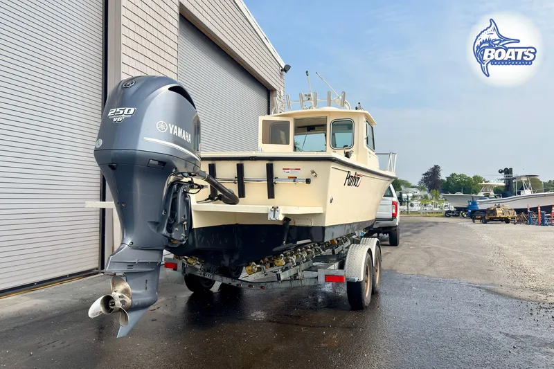 Slide: The Image of 2011 Parker Sport Cabin SL boat on trailer with Yamaha 250 V6 engine. - 9