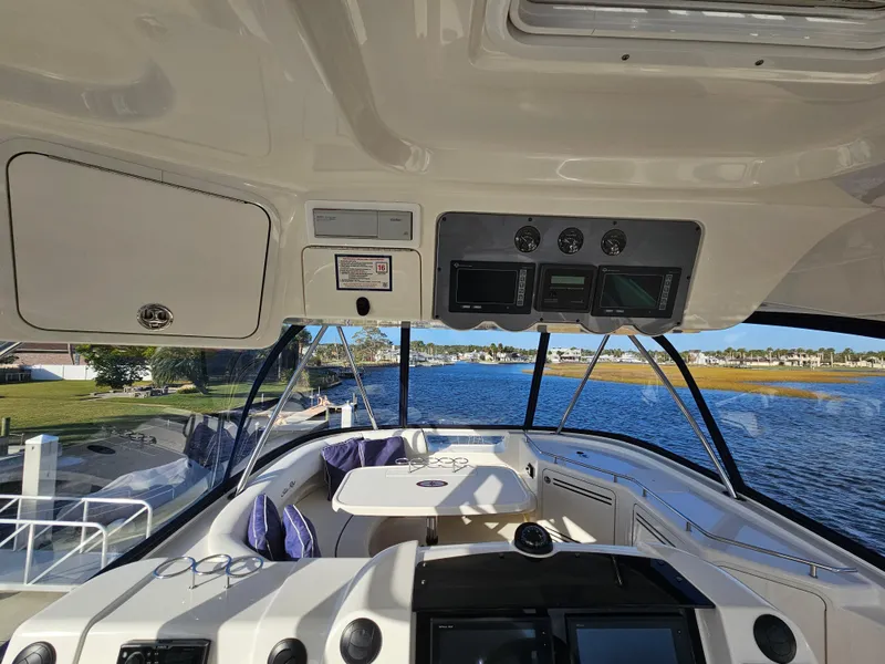 Slide: The Image of Interior view of 2006 Sea Ray 580 Sedan Bridge yacht with scenic water backdrop. - 15