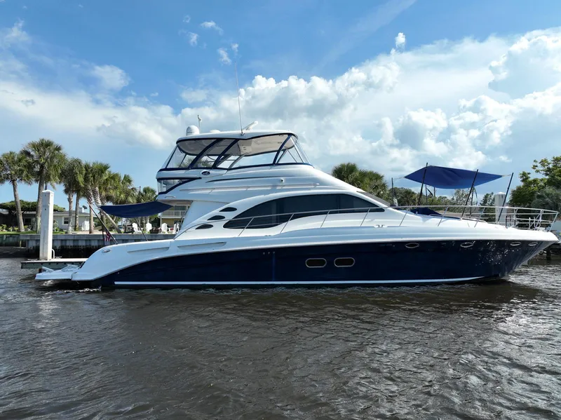Slide: The Image of 2006 Sea Ray 580 Sedan Bridge yacht docked on a sunny day. - 2