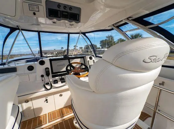 Slide: The Image of Interior view of 2006 Sea Ray 580 Sedan Bridge yacht cockpit with helm and seating. - 21