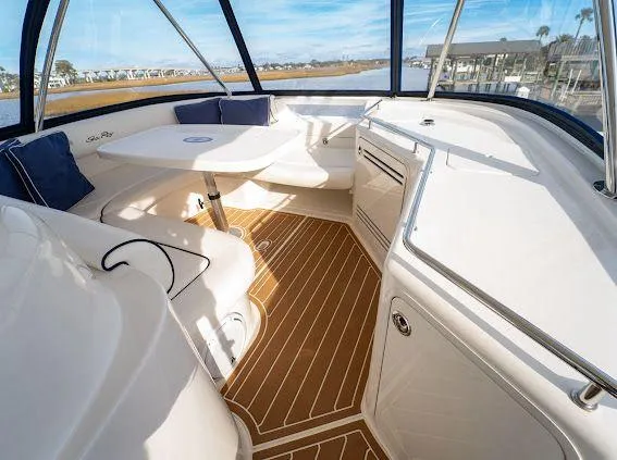 Slide: The Image of 2006 Sea Ray 580 Sedan Bridge interior with seating, table, and panoramic windows. - 22