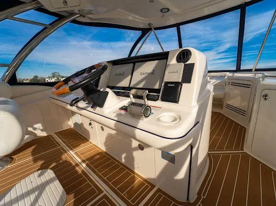 Slide: The Image of Helm of 2006 Sea Ray 580 Sedan Bridge with Garmin navigation, wooden flooring, and panoramic windows. - 24