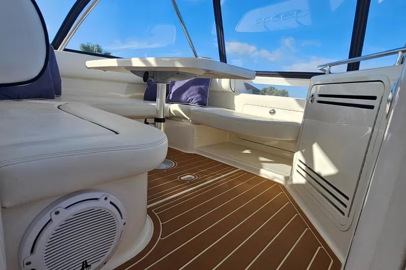 Slide: The Image of Interior of 2006 Sea Ray 580 Sedan Bridge with seating and table, featuring wood flooring. - 25