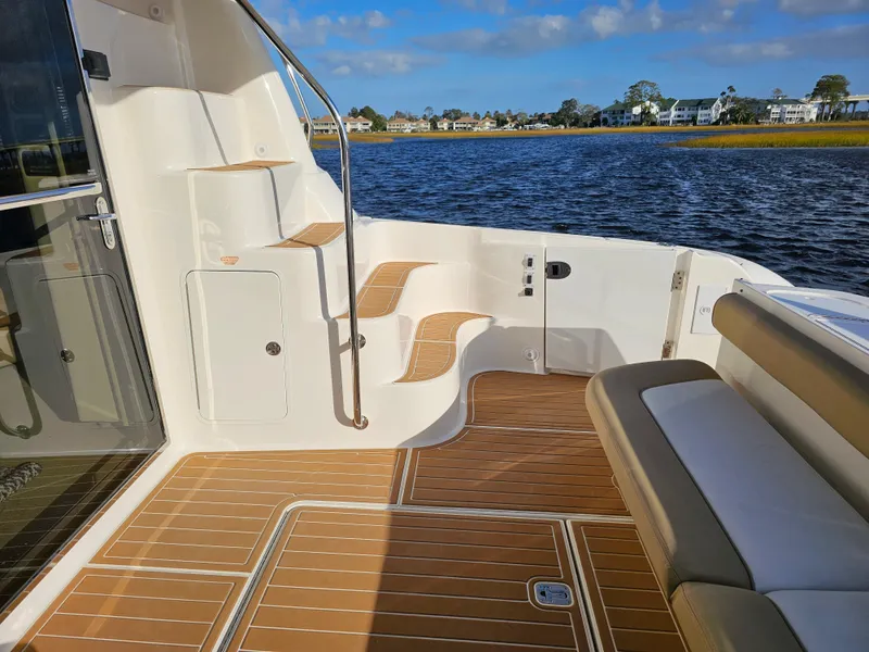 Slide: The Image of 2006 Sea Ray 580 Sedan Bridge yacht deck with seating and water view. - 27
