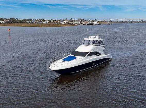 Slide: The Image of 2006 Sea Ray 580 Sedan Bridge yacht cruising on a calm river. - 3