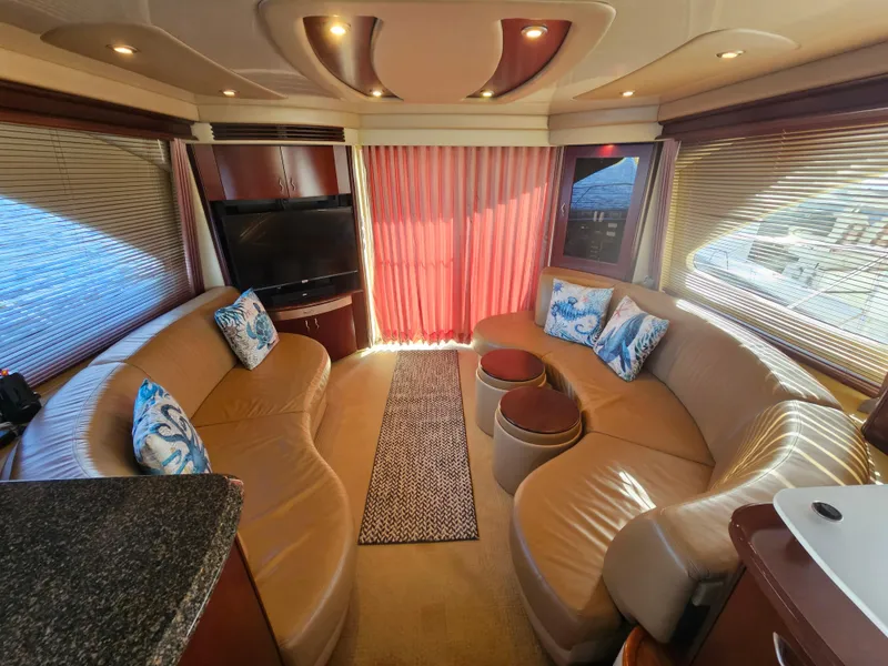 Slide: The Image of Luxurious interior of 2006 Sea Ray 580 Sedan Bridge yacht with plush seating and elegant decor. - 30