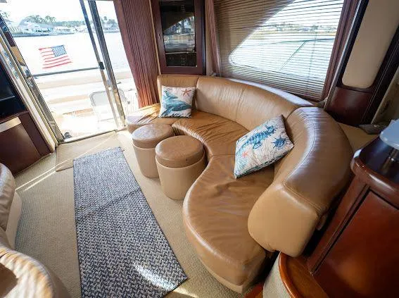 Slide: The Image of Luxurious interior of 2006 Sea Ray 580 Sedan Bridge with leather seating and decorative pillows. - 31