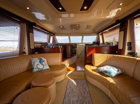 Slide: The Image of Luxurious interior of 2006 Sea Ray 580 Sedan Bridge yacht with elegant seating and decor. - 32