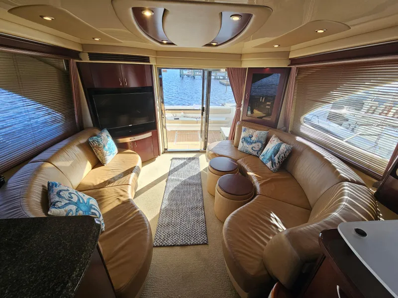 Slide: The Image of Luxurious interior of 2006 Sea Ray 580 Sedan Bridge yacht with leather seating and waterfront view. - 35