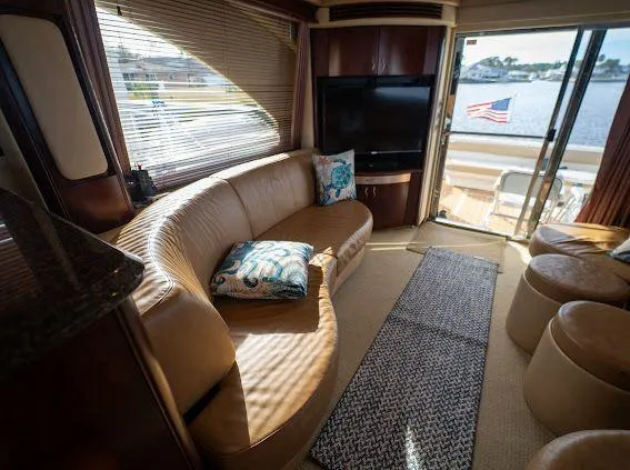 Slide: The Image of Luxurious 2006 Sea Ray 580 Sedan Bridge interior with leather seating and waterfront view. - 37