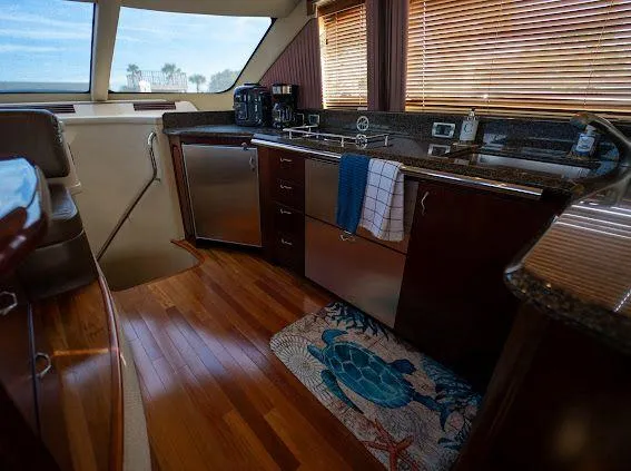 Slide: The Image of Luxurious 2006 Sea Ray 580 Sedan Bridge yacht interior with modern kitchen and wooden flooring. - 40