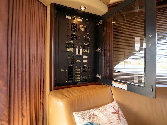 Slide: The Image of Electrical panel inside 2006 Sea Ray 580 Sedan Bridge yacht, next to leather seating. - 43