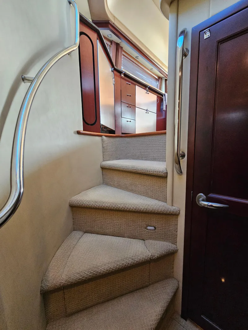 Slide: The Image of Interior staircase of 2006 Sea Ray 580 Sedan Bridge yacht with carpeted steps. - 44