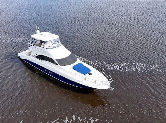 Slide: The Image of 2006 Sea Ray 580 Sedan Bridge yacht cruising on open water. - 7