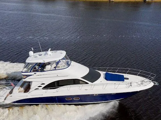 Slide: The Image of 2006 Sea Ray 580 Sedan Bridge yacht cruising on open water. - 8