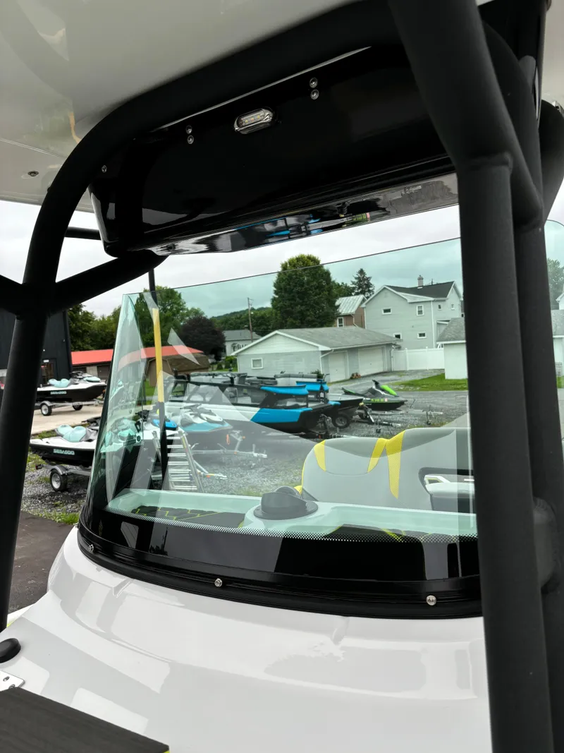 Slide: The Image of 2025 Scarab 255 Open SE boat windshield with outdoor background. - 10