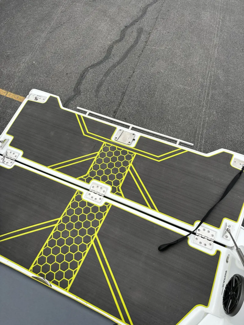 Slide: The Image of 2025 Scarab 255 Open SE boat deck with yellow hexagonal design. - 14