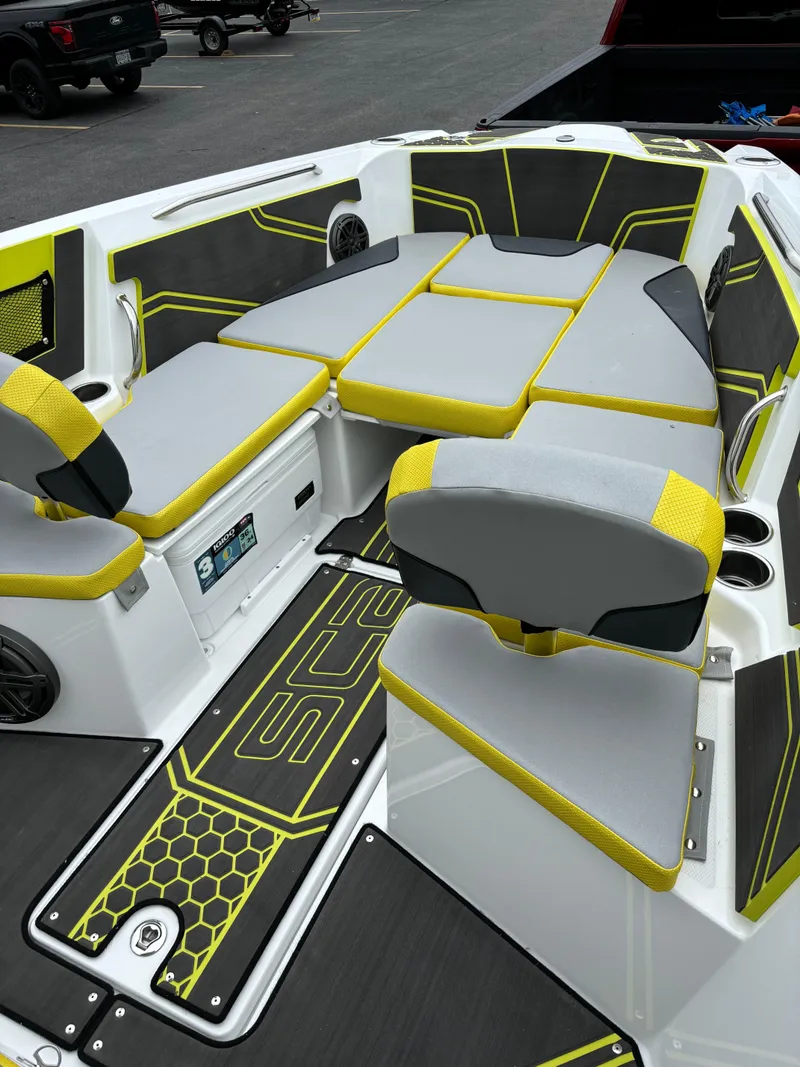 Slide: The Image of 2025 Scarab 255 Open SE boat on trailer, vibrant yellow and black design. - 2