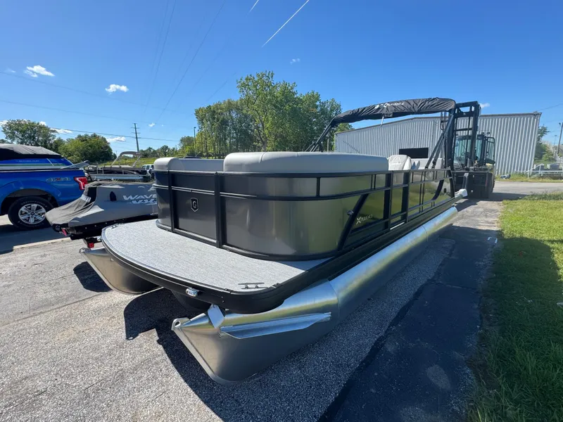 The Image of 2025 Godfrey EX2286SFLX pontoon boat parked outdoors on a sunny day. - 0