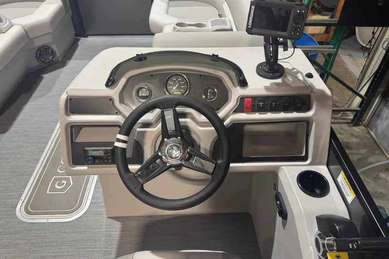 Slide: The Image of 2025 Godfrey Xperience EX2286SFLX boat dashboard with steering wheel and navigation system. - 14