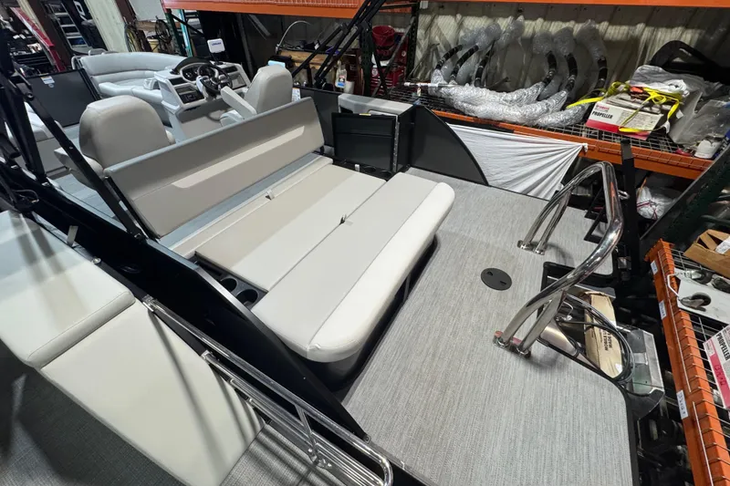 Slide: The Image of 2025 Godfrey Xperience EX2286SFLX boat interior with seating and steering console. - 19