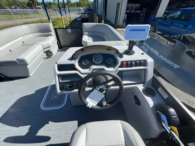Slide: The Image of Interior view of 2025 Godfrey EX2286SFLX pontoon boat with steering console and seating. - 4