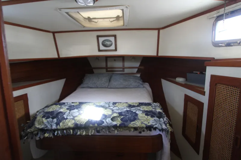 Slide: The Image of Cozy cabin interior of 2000 Willard Marine 40 Flybridge Sedan Trawler with bed and floral blanket. - 13
