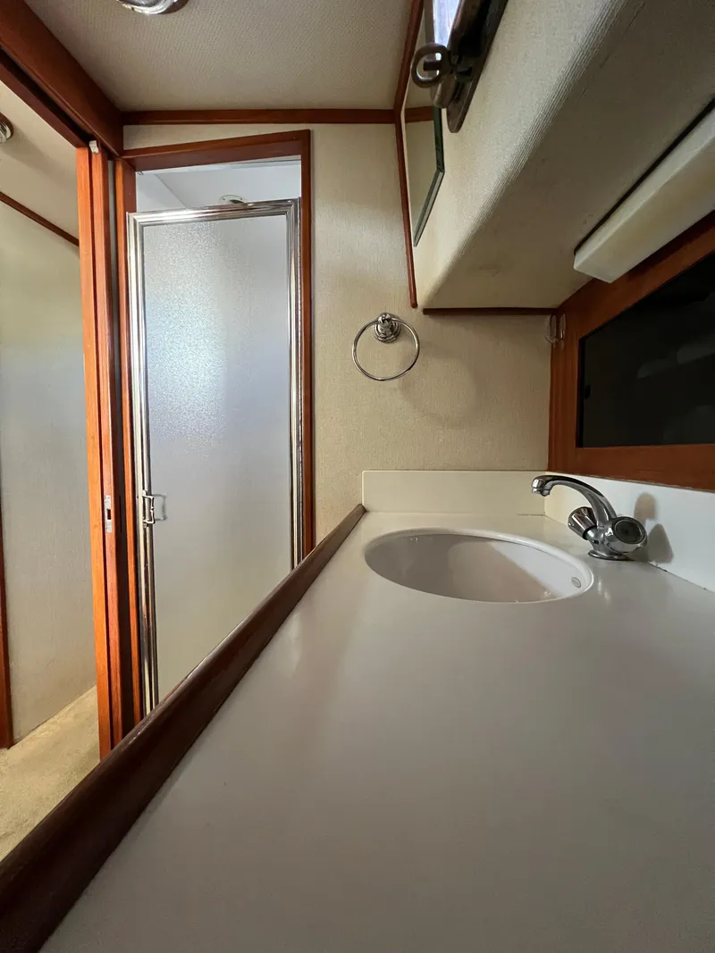 Slide: The Image of Interior of 2000 Willard Marine 40 Flybridge Sedan Trawler bathroom with sink and shower. - 14