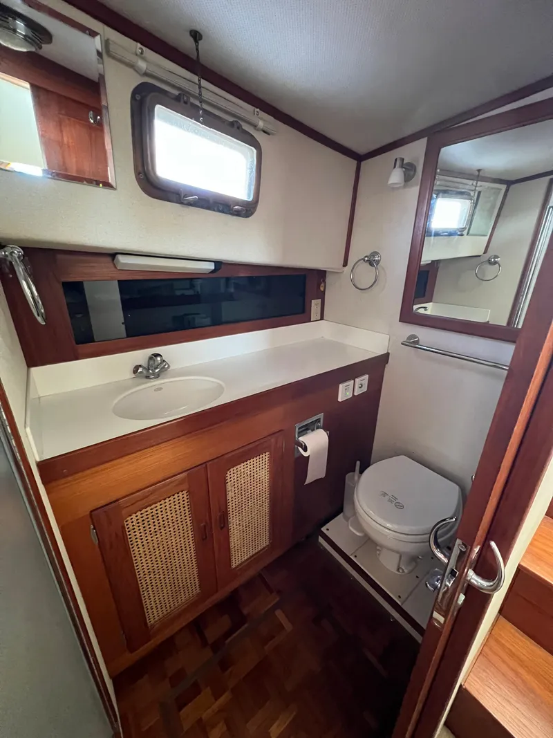 Slide: The Image of Bathroom interior of 2000 Willard Marine 40 Flybridge Sedan Trawler, featuring sink and toilet. - 15